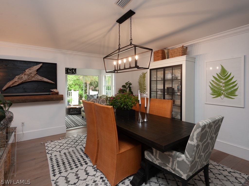 1434 Sand Castle Road Sanibel, FL 33957 - Photo 13 of 35 a view of a dining room with furniture and chandelier