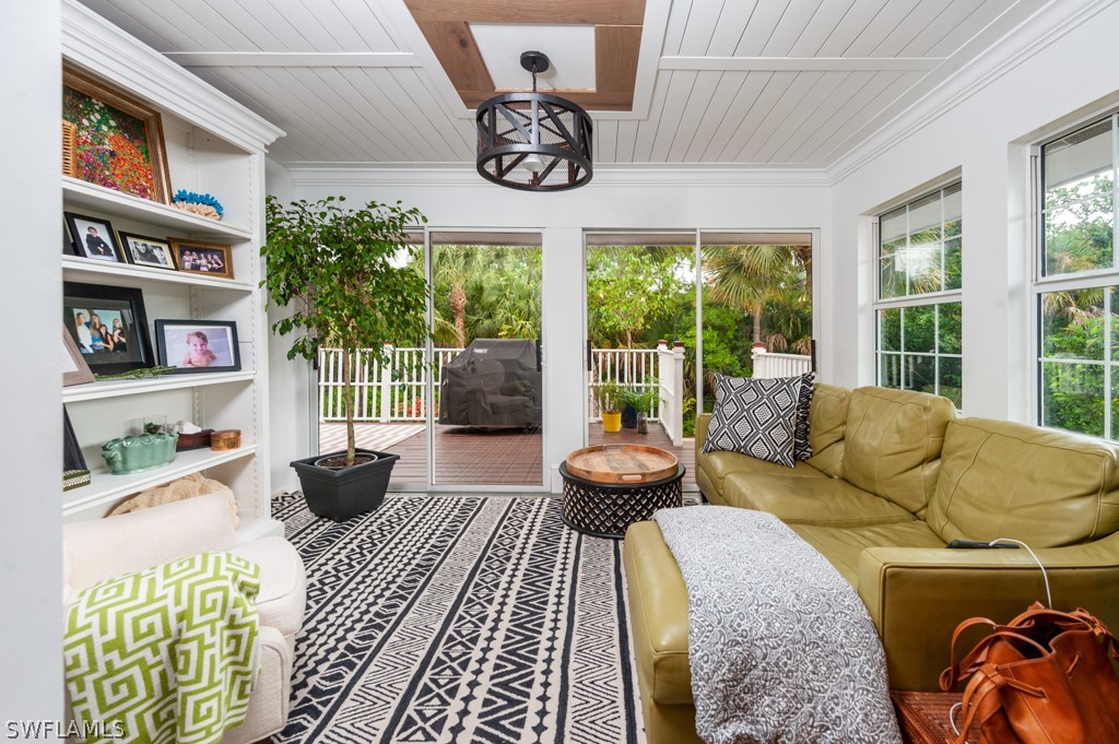 1434 Sand Castle Road Sanibel, FL 33957 - Photo 14 of 35 a living room with furniture and a floor to ceiling window