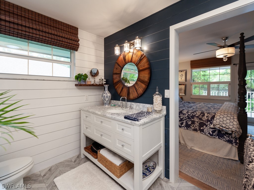 1434 Sand Castle Road Sanibel, FL 33957 - Photo 17 of 35 a bathroom with a sink mirror vanity and toilet