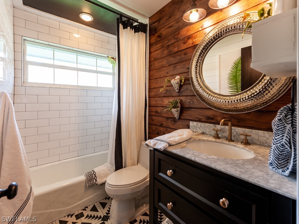 1434 Sand Castle Road Sanibel, FL 33957 - Photo 21 of 35 a bathroom with a granite countertop toilet sink mirror vanity and shower