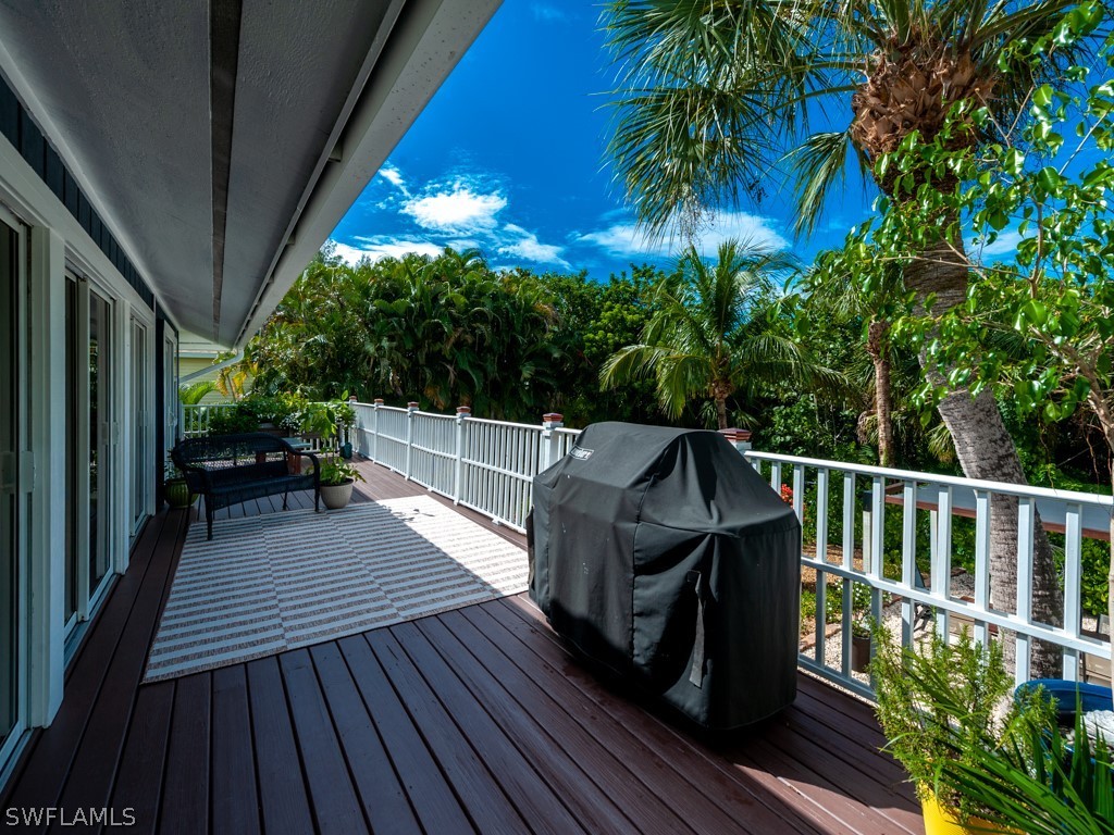 1434 Sand Castle Road Sanibel, FL 33957 - Photo 24 of 35 a view of a balcony with wooden floor and fence