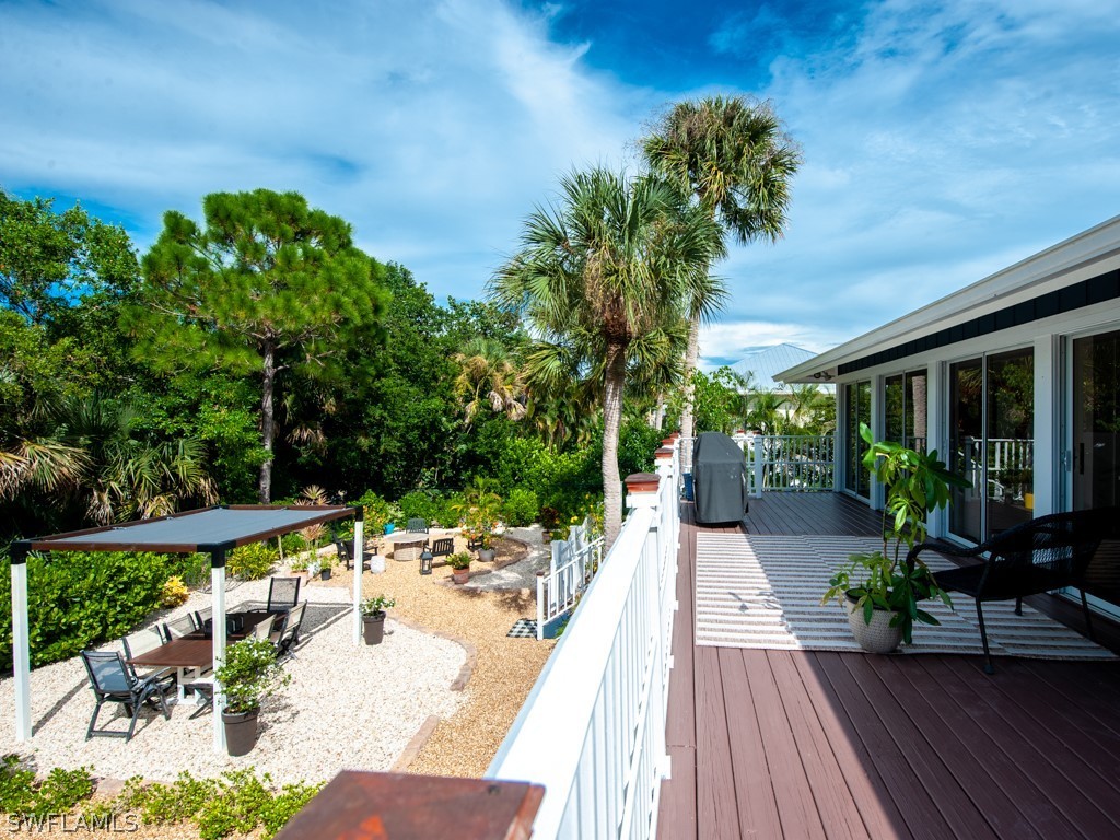 1434 Sand Castle Road Sanibel, FL 33957 - Photo 26 of 35 a view of a house with backyard and sitting area