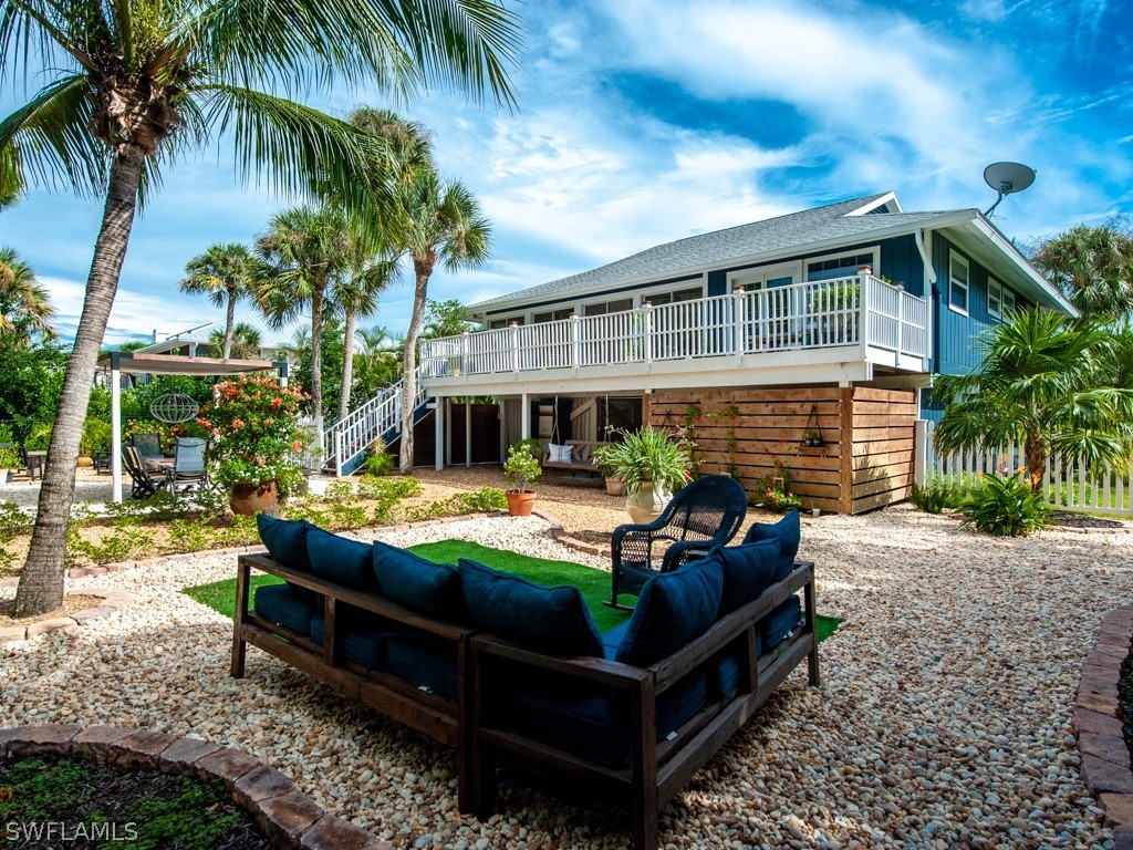 1434 Sand Castle Road Sanibel, FL 33957 - Photo 3 of 35 a front view of house with outdoor seating