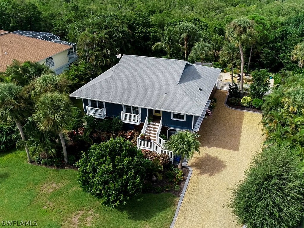 1434 Sand Castle Road Sanibel, FL 33957 - Photo 31 of 35 an aerial view of a house with yard and green space