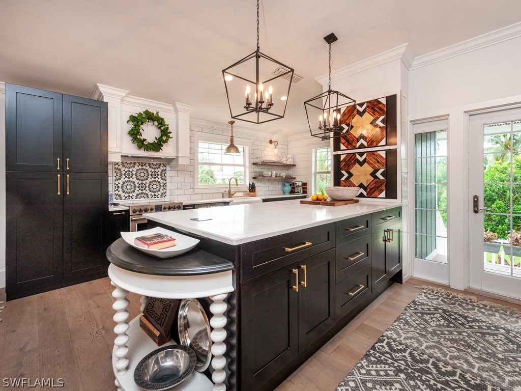 1434 Sand Castle Road Sanibel, FL 33957 - Photo 8 of 35 a kitchen with a sink and a refrigerator