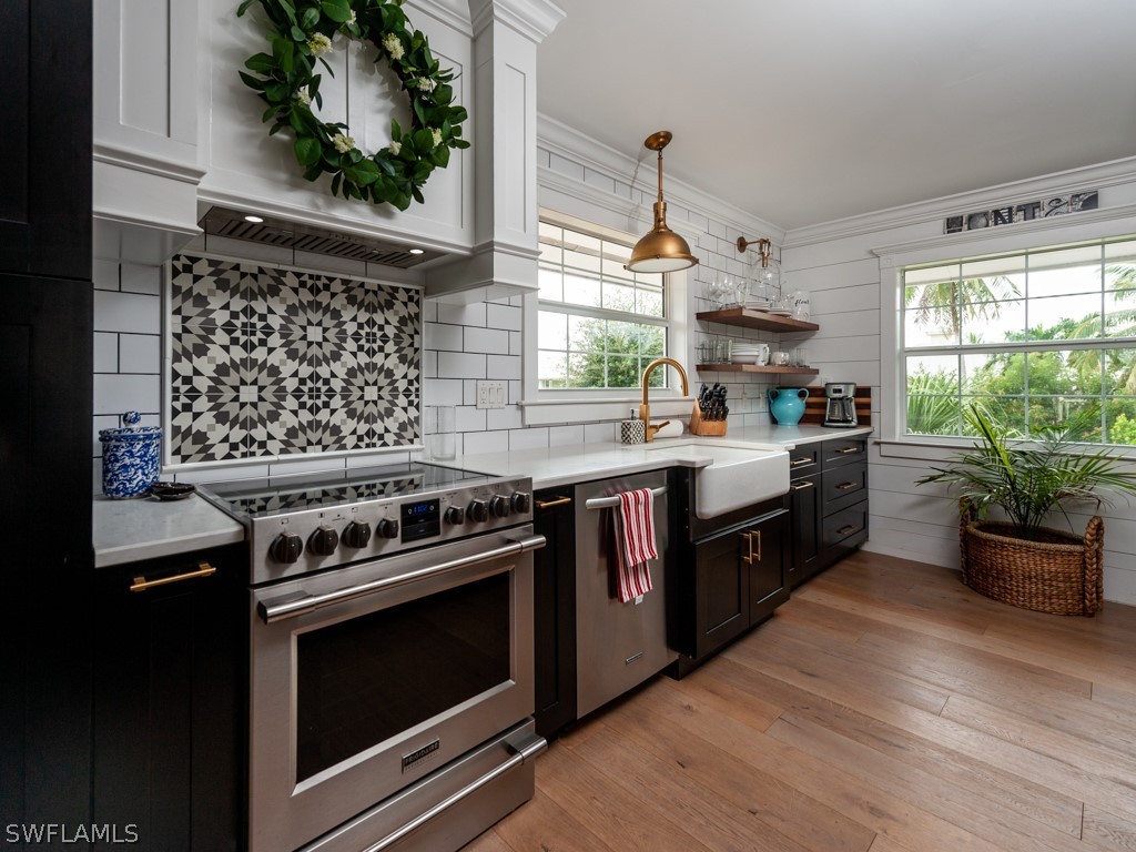 1434 Sand Castle Road Sanibel, FL 33957 - Photo 10 of 35 a kitchen with a stove a sink and a window
