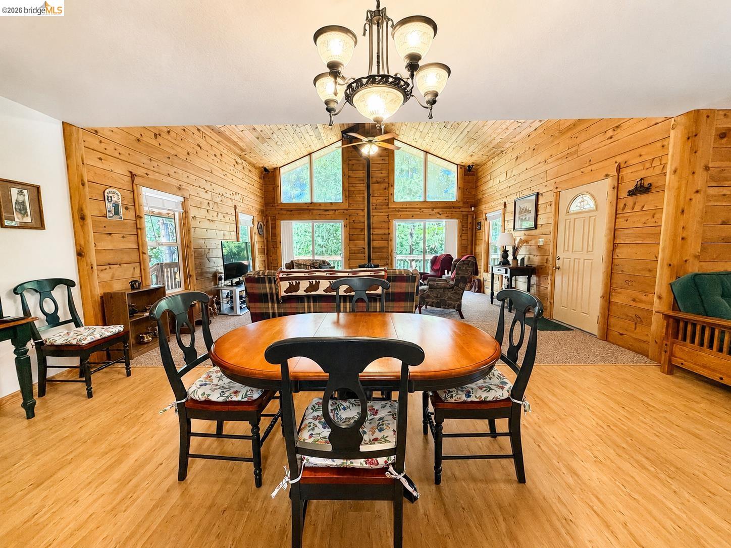 21181 Phoenix Lake Road Sonora, CA 95370 - Photo 12 of 34 Spacious dining area featuring wood-finish flooring, a decorative chandelier, and an open-concept layout