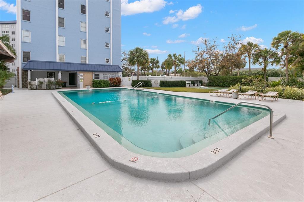 4939 Floramar Terrace, Unit 208 New Port Richey, FL 34652 - Photo 22 of 36 a view of a swimming pool with a yard