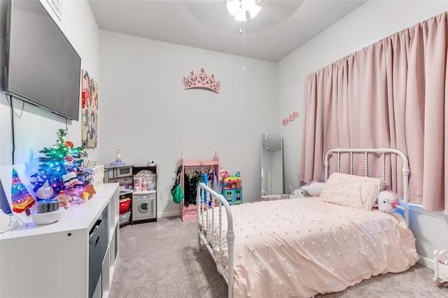 a bedroom with a bed and a white cabinet
