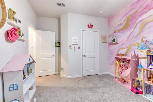 a bedroom with furniture and a large window