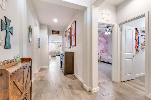 a view of a hallway view with furniture and wooden floor