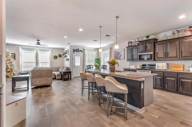 a large kitchen with a table and chairs