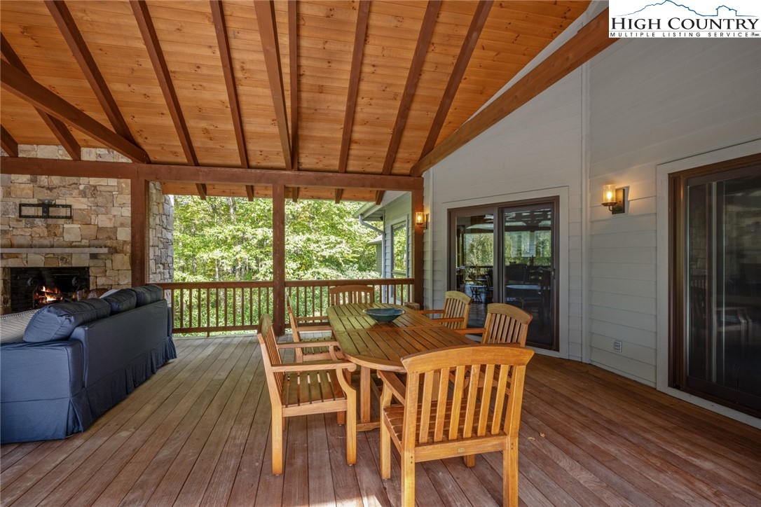 171 Balsam Road Linville, NC 28646 - Photo 18 of 49 a dining room with furniture a fireplace and wooden floor