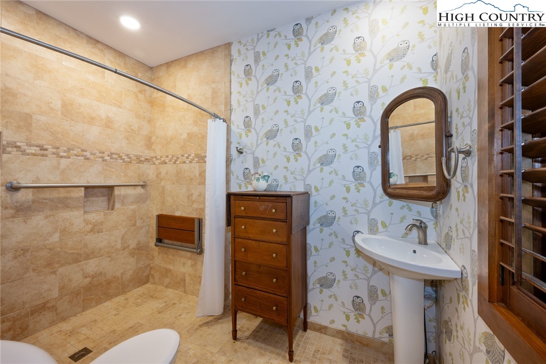 171 Balsam Road Linville, NC 28646 - Photo 27 of 49 a bathroom with a sink mirror and toilet