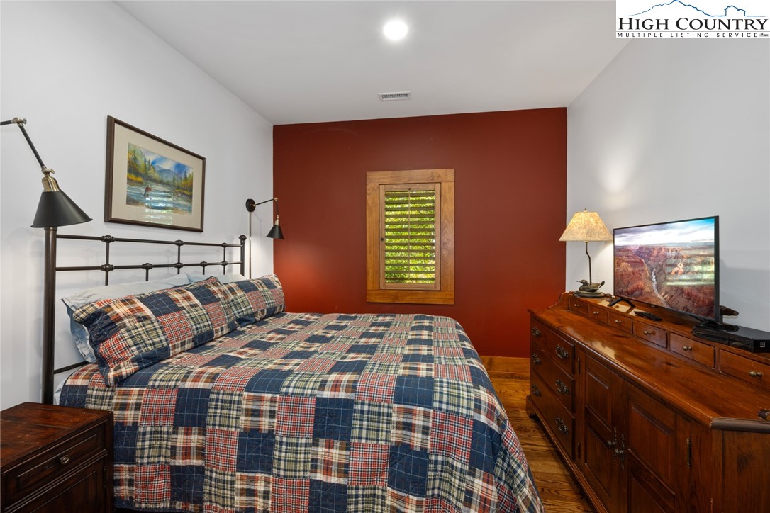 171 Balsam Road Linville, NC 28646 - Photo 34 of 49 a bedroom with a bed and a flat screen tv