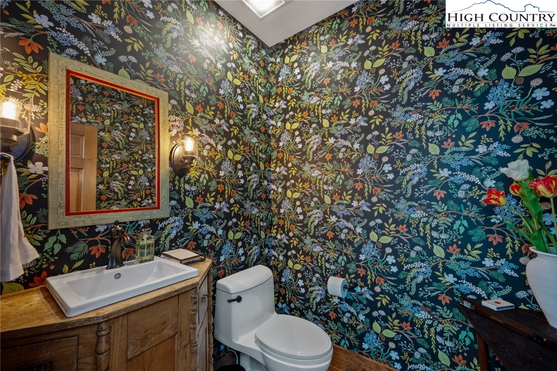 171 Balsam Road Linville, NC 28646 - Photo 36 of 49 a bathroom with a toilet sink and mirror