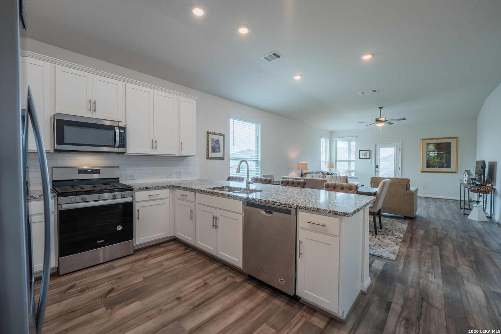 4947 Ranahan Pass St. Hedwig, TX 78152 - Photo 7 of 37 a kitchen with sink cabinets and wooden floor