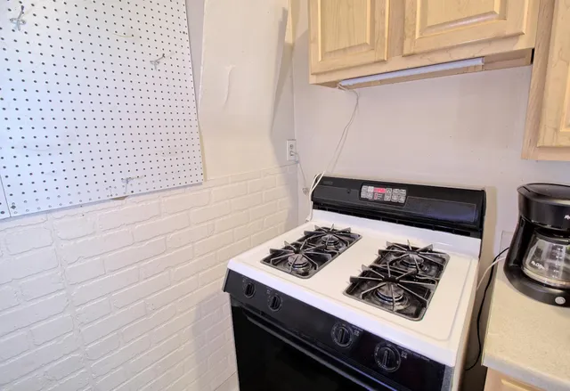 a white stove top oven sitting inside of a kitchen