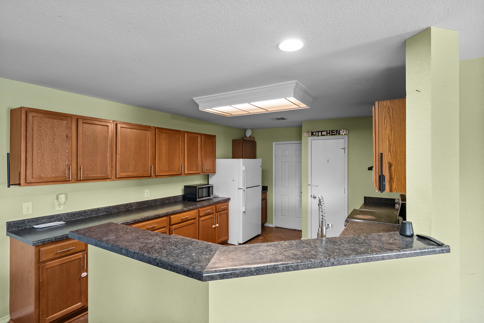 6829 Walkup Lane Austin, TX 78747 - Photo 7 of 18 A functional kitchen boasts ample counter space and well-maintained cabinetry.
