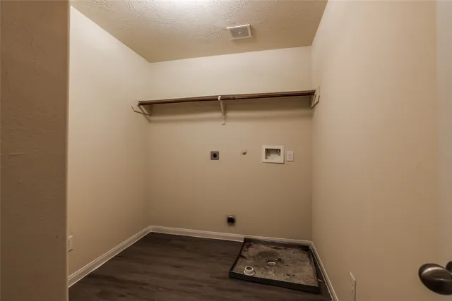 a room with a walk in closet and wooden floor