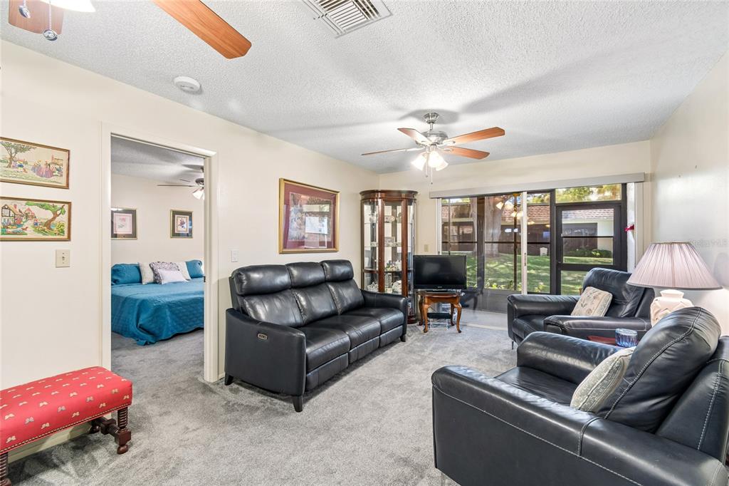 11340 Carriage Hill Drive, Unit 4 Port Richey, FL 34668 - Photo 13 of 36 a living room with furniture and a large window