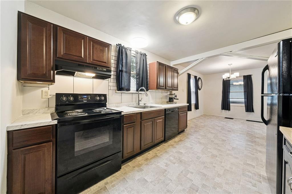 2052 McKinney Road Monroeville, PA 15146 - Photo 14 of 30 a large kitchen with stainless steel appliances granite countertop a stove a sink dishwasher and a refrigerator