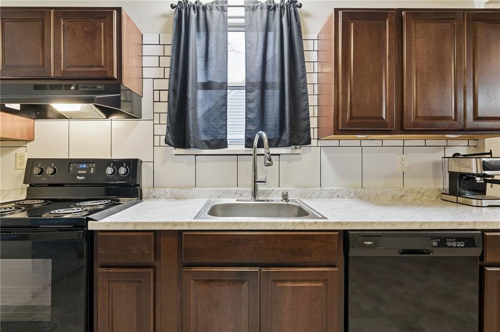 2052 McKinney Road Monroeville, PA 15146 - Photo 15 of 30 a kitchen with stainless steel appliances granite countertop a sink stove and cabinets
