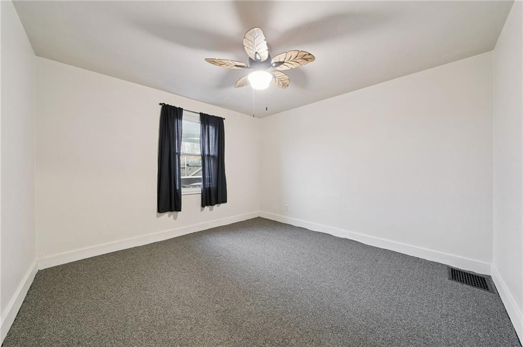 2052 McKinney Road Monroeville, PA 15146 - Photo 18 of 30 an empty room with chandelier fan and windows