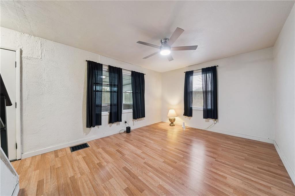 2052 McKinney Road Monroeville, PA 15146 - Photo 9 of 30 a view of an empty room with a window and wooden floor