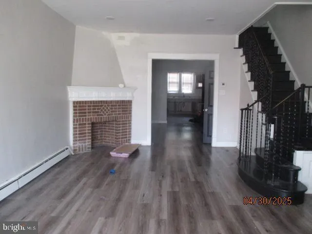 wooden floor in an empty room with a fireplace