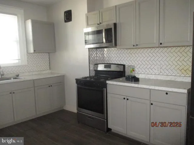 a kitchen with cabinets appliances and a sink