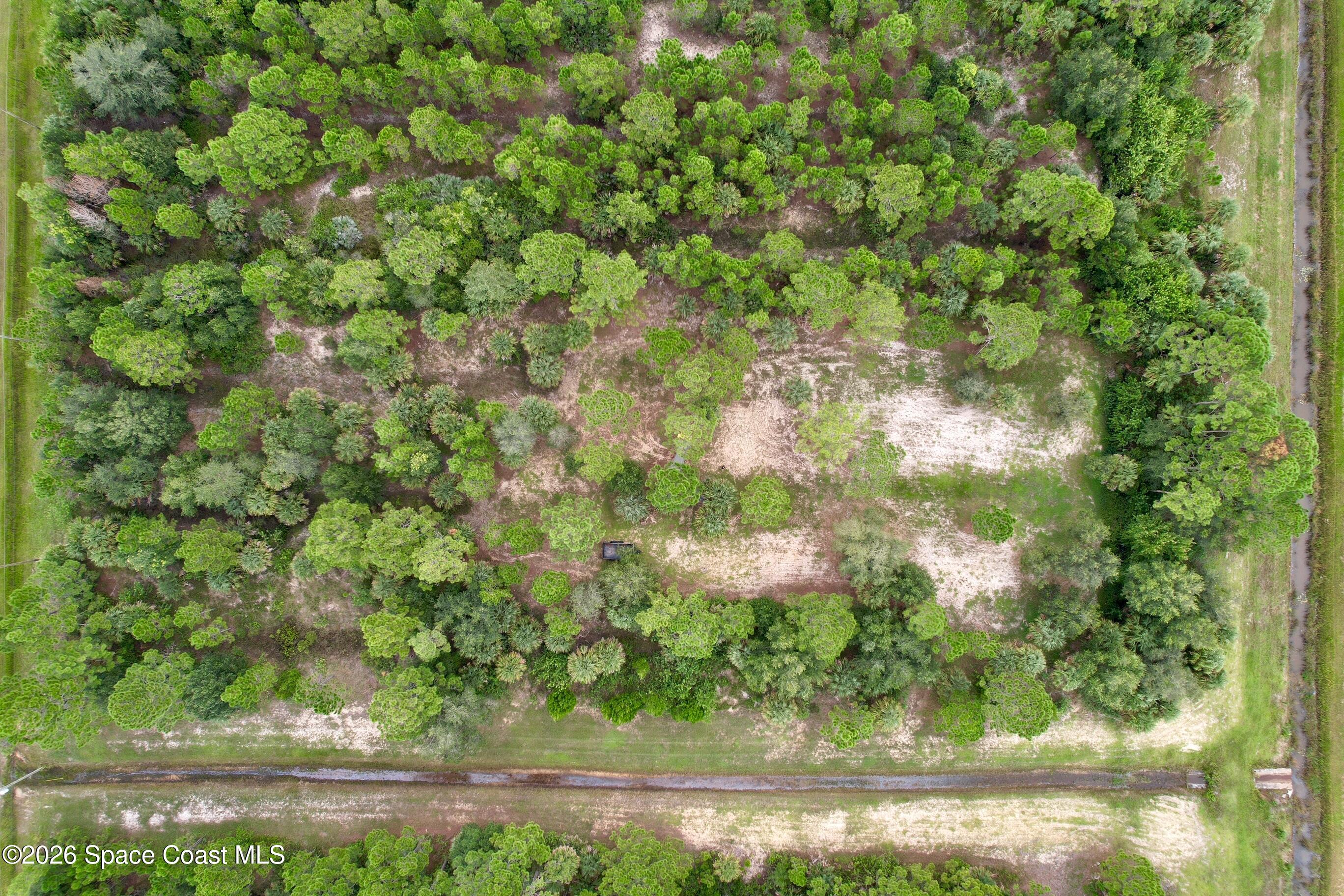 a backyard of a house with lots of green space and garden