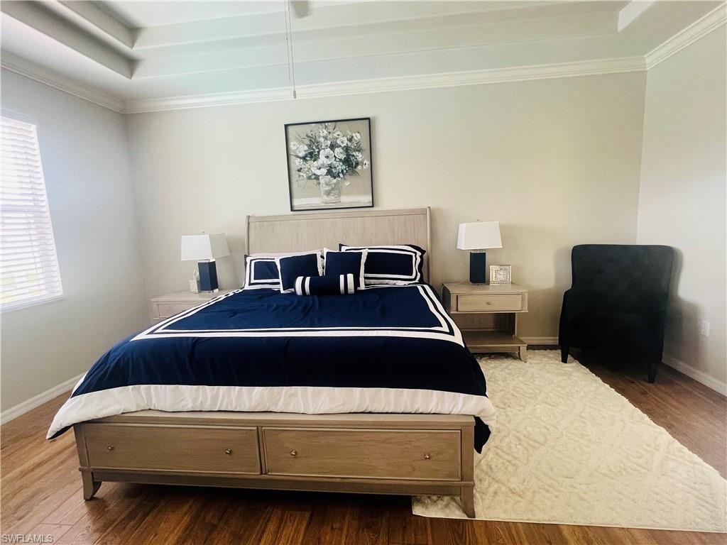 14265 Manchester Drive Naples, FL 34114 - Photo 11 of 35 a bedroom with a bed and chair