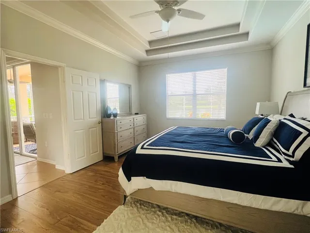 a room with a bed and wooden floor