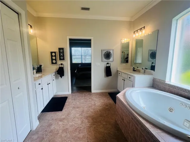 a large bathroom with a double vanity sink a large mirror and a shower