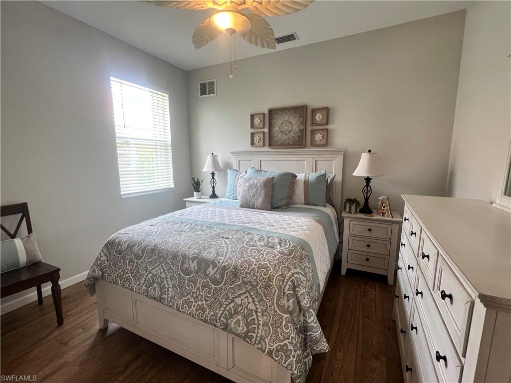 14265 Manchester Drive Naples, FL 34114 - Photo 16 of 35 a bedroom with a bed and a chandelier