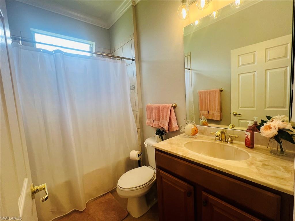 14265 Manchester Drive Naples, FL 34114 - Photo 17 of 35 a bathroom with a sink and a mirror