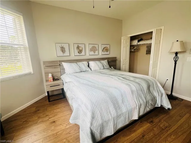 a bed sitting in a bedroom next to a window