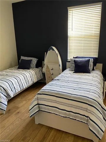 a bedroom with double bed and a window