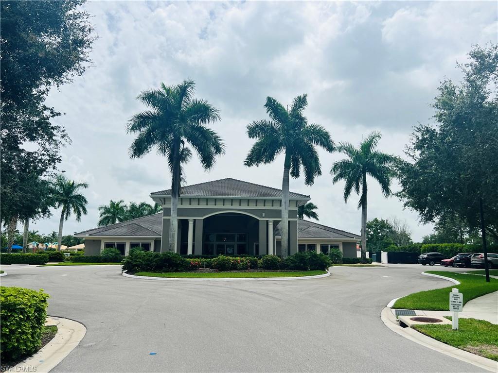 14265 Manchester Drive Naples, FL 34114 - Photo 27 of 35 a front view of a house with garden and trees