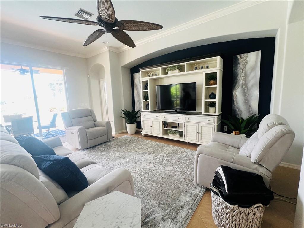 14265 Manchester Drive Naples, FL 34114 - Photo 5 of 35 a living room with furniture and a flat screen tv