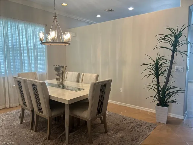 a view of a dining room with furniture wooden floor and chandelier