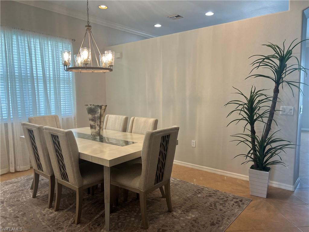14265 Manchester Drive Naples, FL 34114 - Photo 9 of 35 a view of a dining room with furniture wooden floor and chandelier