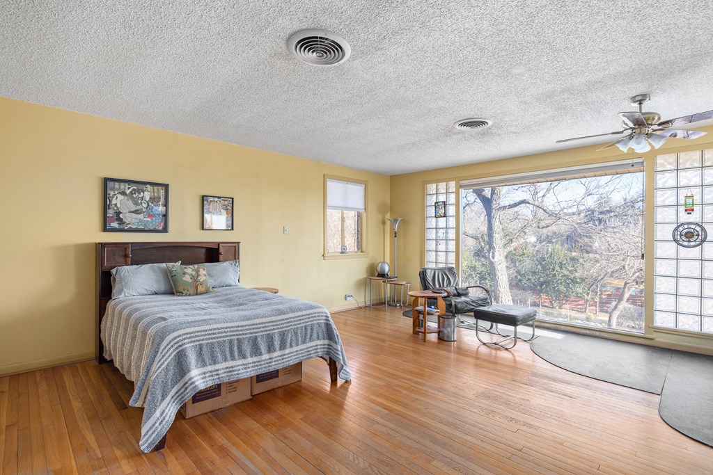 228 Galbraith Avenue Kerrville, TX 78028 - Photo 16 of 50 a bedroom with a large bed and a large window