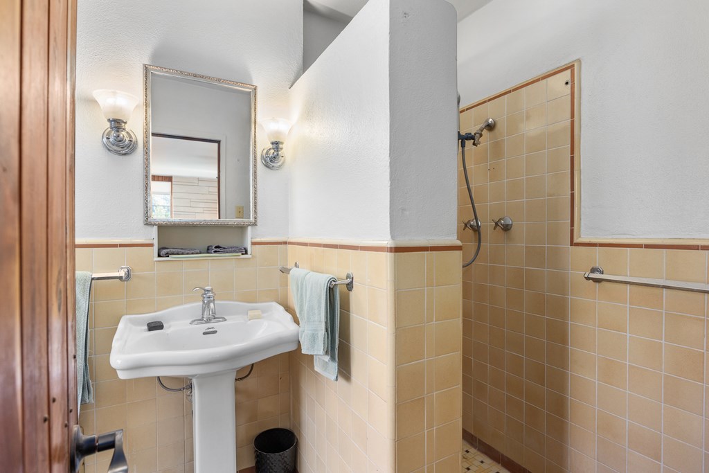 228 Galbraith Avenue Kerrville, TX 78028 - Photo 28 of 50 a bathroom with a sink a mirror and shower