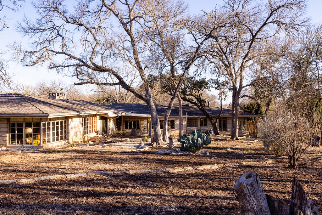 228 Galbraith Avenue Kerrville, TX 78028 - Photo 47 of 50 a front view of a building with trees around