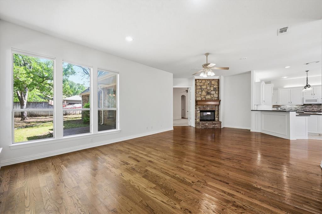 5513 Rustic Trail Colleyville, TX 76034 - Photo 12 of 40 a view of an empty room with a window and wooden floor