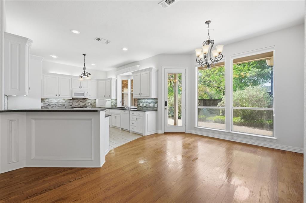 5513 Rustic Trail Colleyville, TX 76034 - Photo 13 of 40 a open kitchen with granite countertop a stove a sink a center island and cabinets