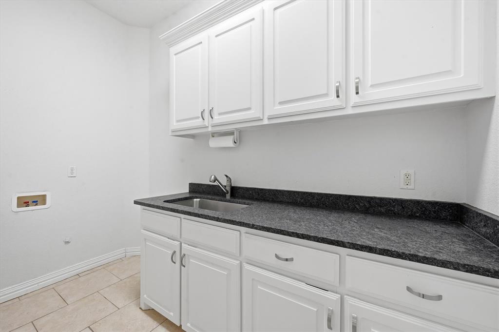 5513 Rustic Trail Colleyville, TX 76034 - Photo 18 of 40 a kitchen with granite countertop white cabinets and a sink