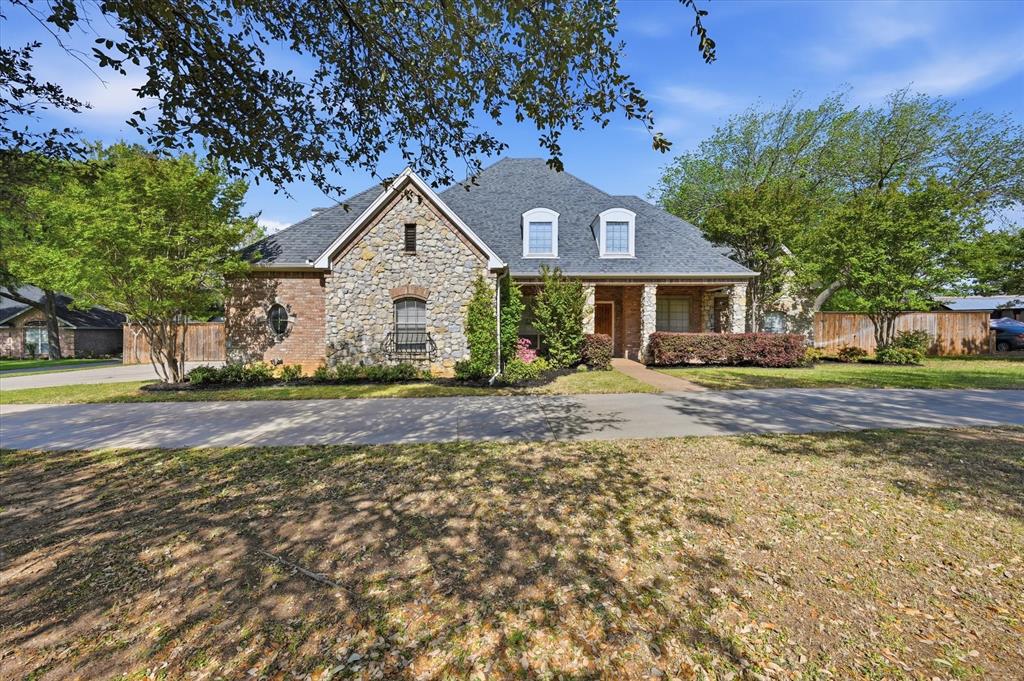 5513 Rustic Trail Colleyville, TX 76034 - Photo 2 of 40 a front view of a house with a yard